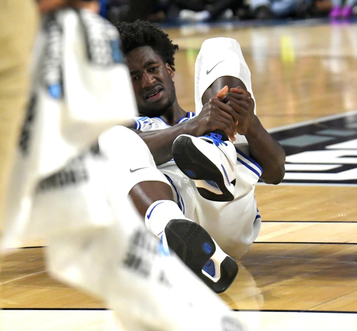 Duke's AJ Griffin writhes in pain after injuring his left ankle in the second half of the Blue Devils' NCAA Tournament game against Michigan State.