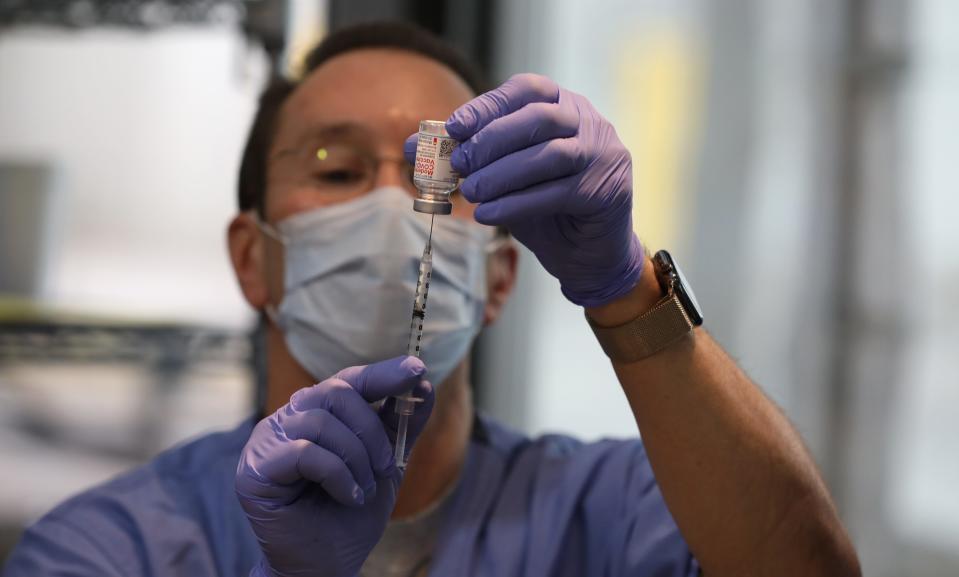 Carl Pepe, pharmacist staff, measures out the exact vaccination dosage moments before its use during a COVID-19 vaccine clinic held at Unity Hospital in Greece on Saturday, Jan. 9, 2021.