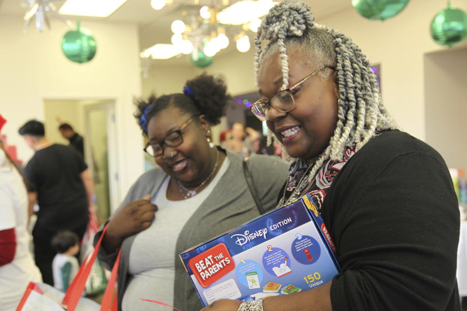 La'Delegant Hartsfield, left, and Stephanie Brodie, right, shop at The Toy Store, a free-referral based toy store, Friday, Dec. 8, 2023, in Nashville, Tenn. The facility is co-founded by Brad Paisley and Kimberly Williams-Paisley. The couple also started The Store, a free-referral based grocery store they opened in partnership with Belmont University in March 2020. (AP Photo/Kristin M. Hall)