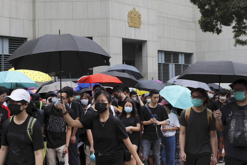 Protesters with umbrellas gather outside the British Consulate in Hong Kong, Wednesday, June 26, 2019. Hong Kong activists opposed to contentious extradition legislation on Wednesday called on leaders of the U.S., the European Union and others to raise the issue with Chinese President Xi Jinping at this week's G-20 summit in Japan. (AP Photo/Kin Cheung)