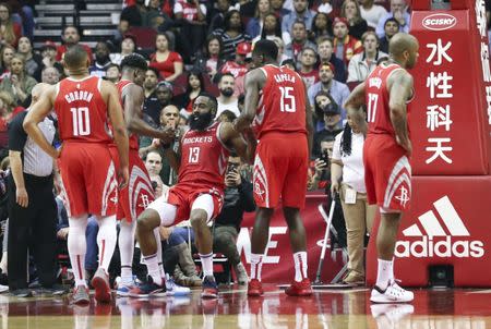 Mar 15, 2019; Houston, TX, USA; Houston Rockets guard James Harden (13) is helped up by teammates after he was fouled by the Phoenix Suns in the second half at Toyota Center. Mandatory Credit: Thomas B. Shea-USA TODAY Sports