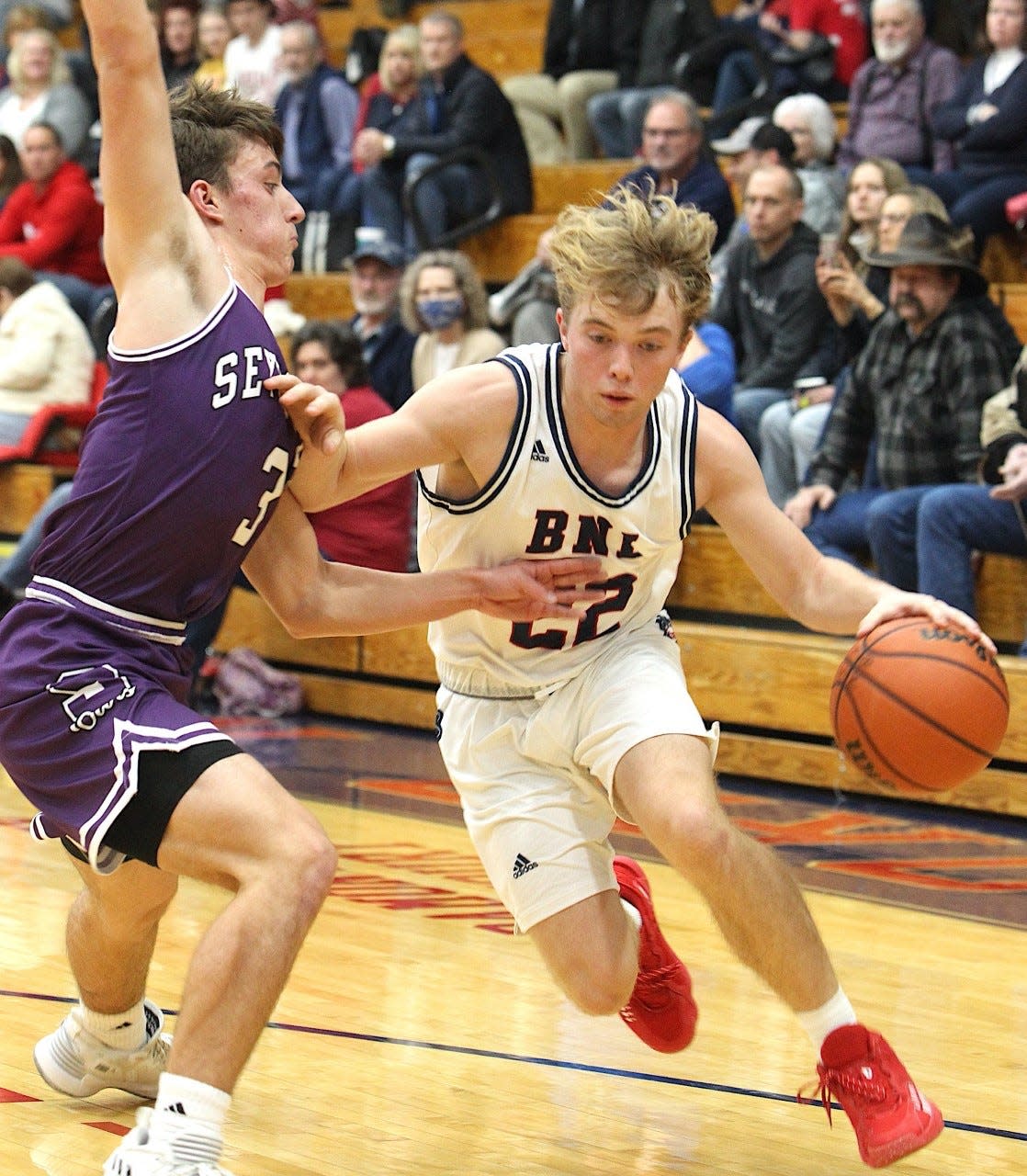 BNL's Colton Staggs drives on Seymour's Bret Perry Friday night at BNL Fieldhouse.