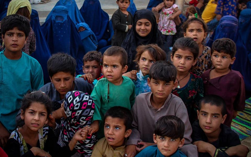 Afghan children arriving from the districts of Khan Abad, Ali Abad and Imam Sahib after fleeing from ongoing battles between the Taliban and Afghan security forces - AFP 