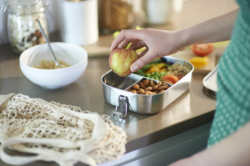 A woman is packing her lunch