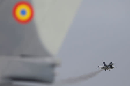 A F-16 plane prepares to touch down at 86th Air Base of Romanian Air Force after performing a flight during the official presentation ceremony of 6 F-16 planes bought by the Romanian government, in Fetesti, Calarasi county, Romania October 7, 2016. Inquam Photos/Octav Ganea/via REUTERS