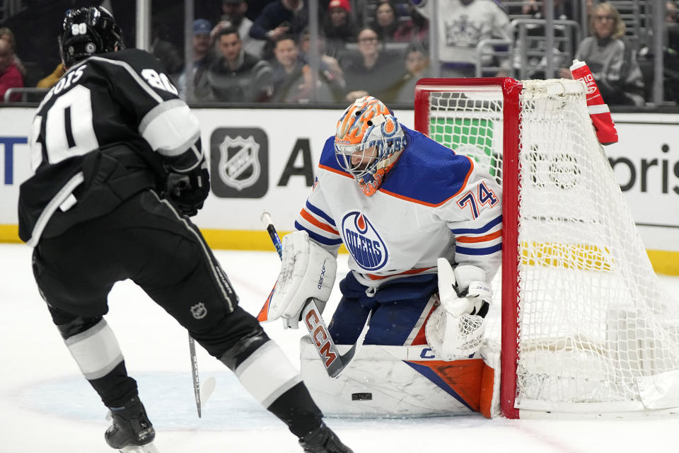 Edmonton Oilers goaltender Stuart Skinner, right, stops a shot by Los Angeles Kings center Pierre-Luc Dubois during the second period of an NHL hockey game Saturday, Dec. 30, 2023, in Los Angeles. (AP Photo/Mark J. Terrill)