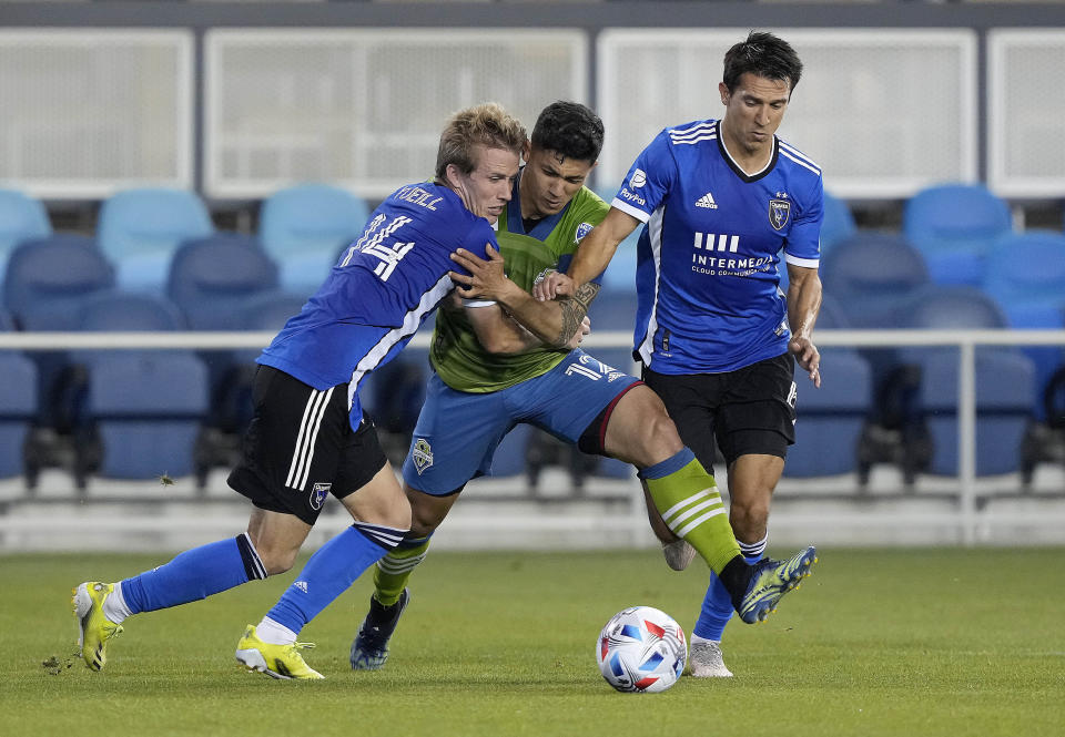 Seattle Sounders forward Fredy Montero, center, works for the ball against San Jose Earthquakes midfielder Jackson Yueill (14) and midfielder Shea Salinas during the second half of an MLS soccer match Wednesday, May 12, 2021, in San Jose, Calif. The Sounders won 1-0. (AP Photo/Tony Avelar)