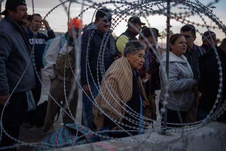 Concertina wire is pictured as people wait in line at the San Ysidro Port of Entry after the land border crossing was temporarily closed to foot and vehicle traffic from Tijuana, Mexico November 19, 2018. REUTERS/Adrees Latif