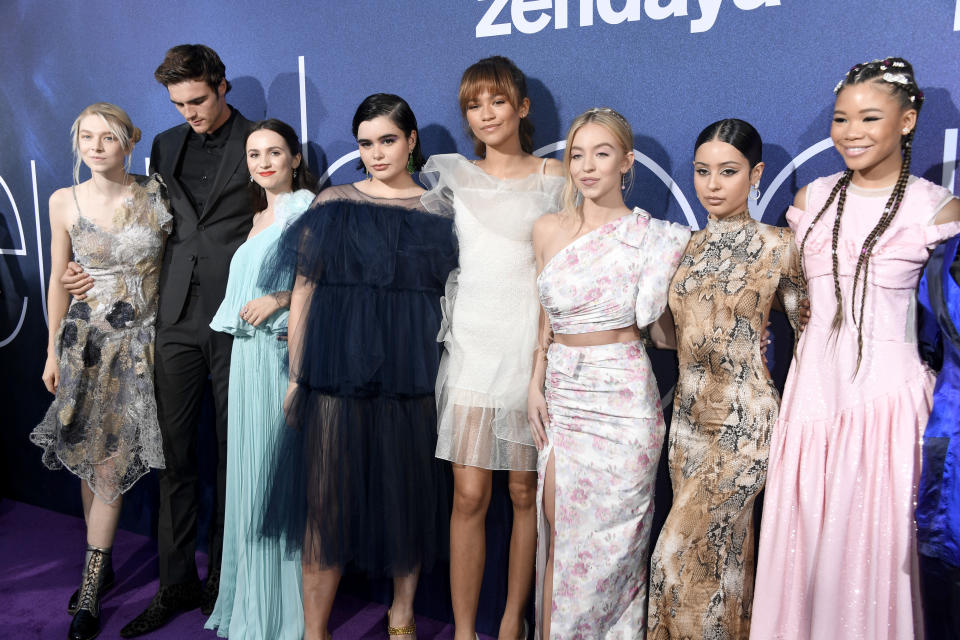 The cast of Euphoria—Hunter Schafer, Jacob Elordi, Maude Apatow, Barbie Ferreira, Zendaya, Sydney Sweeney, Alexa Demie, and Storm Reid—pose together in stylish outfits on the red carpet