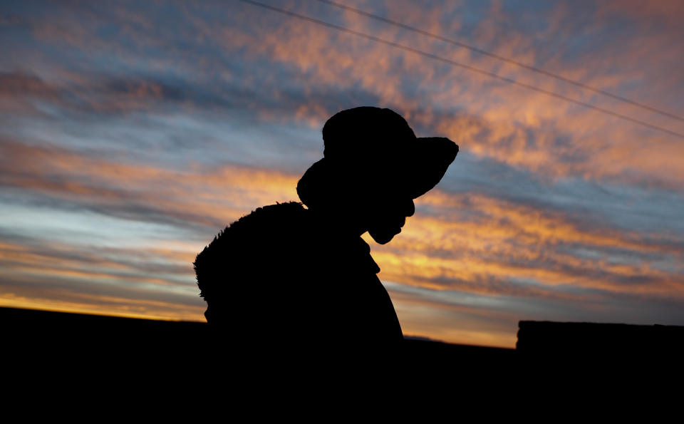Mayor Rufino Choque is silhouetted against a sunset sky in the Urus del Lago Poopo Indigenous community, in Punaca, Bolivia, Sunday, May 23, 2021. “Our grandfathers thought the lake would last all their lives, and now my people are near extinction because our source of life has been lost," said Luis Valero, leader of the Uru communities around Lake Poopo, Bolivia's second-largest lake that dried up about five years ago. (AP Photo/Juan Karita)