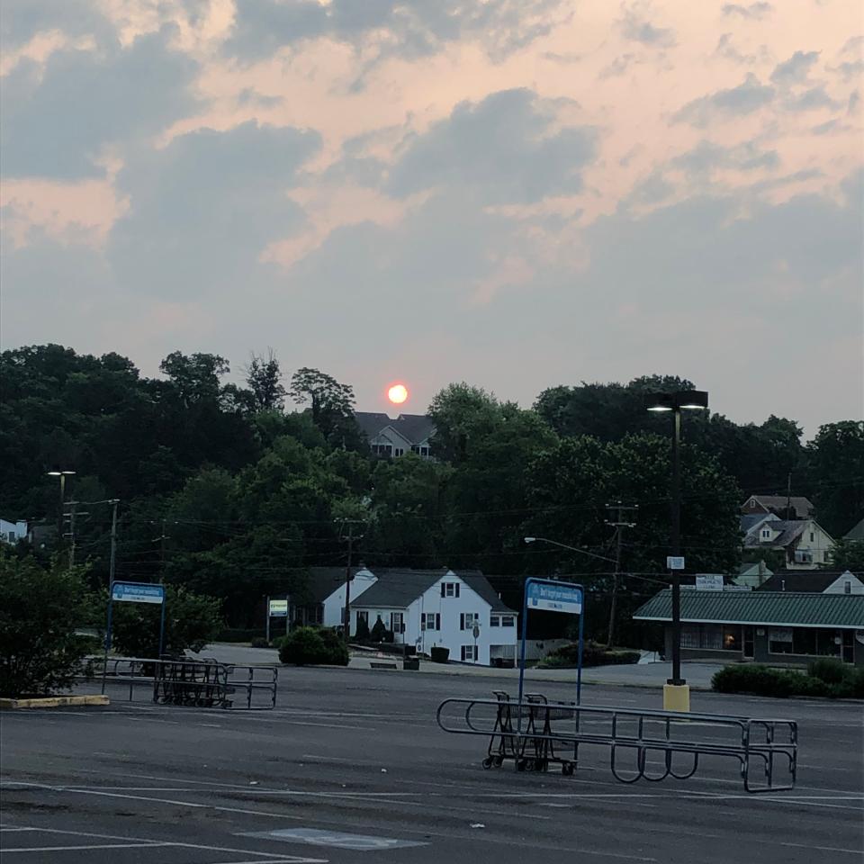 The sun rising through haze from the Canada wildfires, on June 7, 2023. Taken from the Food Lion Parking lot on N. Coalter St.