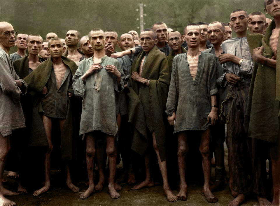 POLAND: Starved prisoners, nearly dead from hunger, pose in concentration camp in Ebensee, Austria. Ebensee was a sub-camp of the main camp 'Mauthausen' near the town of the same name. The camp was reputedly used for 'scientific' experiments. It was liberated by the 80th Division of the U.S. Army in May 1945. HARROWING colourised images of the Holocaust which expose the full terrors faced by the death camp?s inmates have emerged SEVENTY-FIVE-YEARS after the liberation of Auschwitz, the largest Nazi death camp. Sobering photos, some revamped in colour for the first time, capture the horror of genocide in the eyes of a gaunt 18-year-old Russian woman; a concentration camp responsible for the deaths of tens of thousands of innocent people being ceremonially burnt to the ground by liberating British forces; and malnourished Jewish children peering out at their Soviet rescuers through a barbed wire fence at Auschwitz. Other upsetting colourisations include a smiling portrait of four-year-old, Istvan Reiner, taken just a few weeks before he was murdered at the infamous death camp, and another showing a palpably relieved young Jewish refuge recuperating in hospital after being rescued by appalled Allied Forces. Mediadrumimages/TomMarshall(PhotograFix)2020