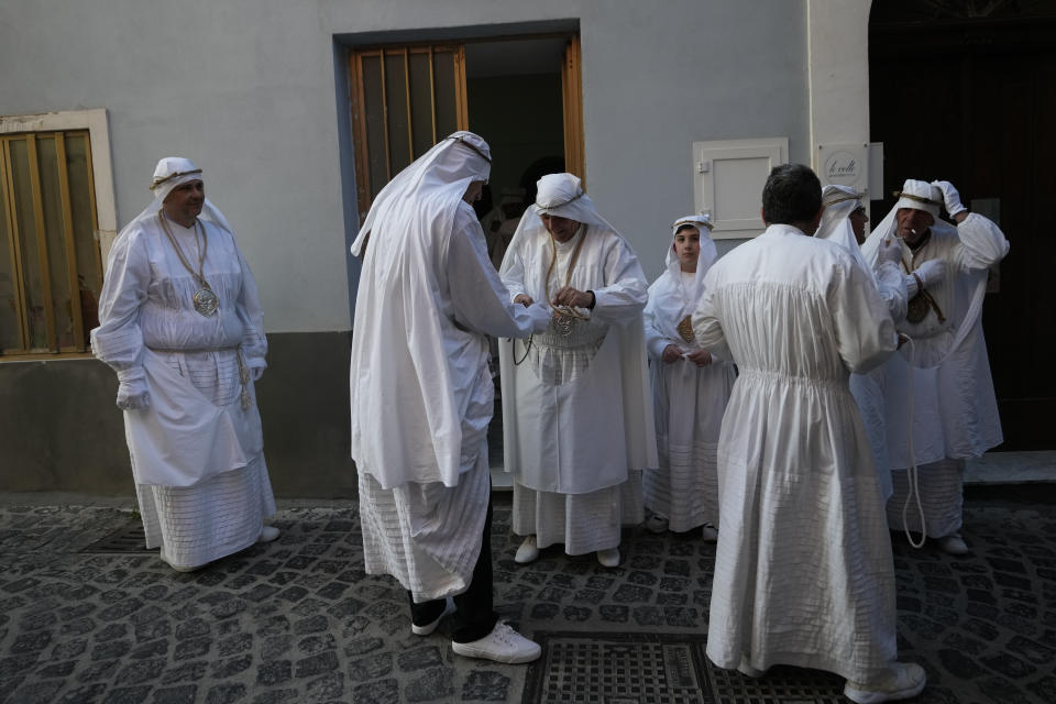 Members of a confraternity wait for the start of a Holy Thursday procession the in Procida Island, Italy, Thursday, March 28, 2024. Italy is known for the religious processions that take over towns big and small when Catholic feast days are celebrated throughout the year. But even in a country where public displays of popular piety are a centuries-old tradition, Procida's Holy Week commemorations stand out.(AP Photo/Alessandra Tarantino)