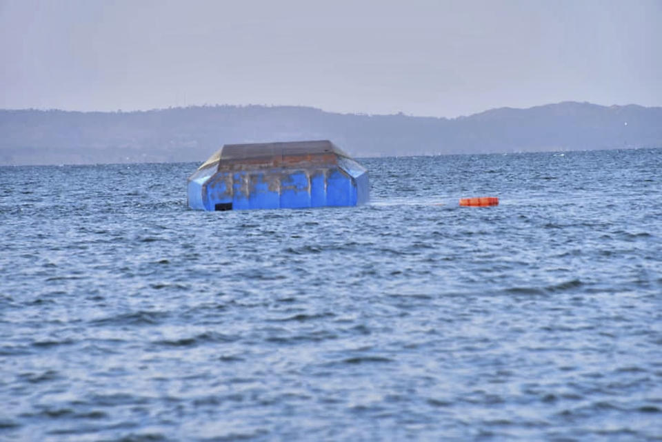 The upturned passenger ferry MV Nyerere floats in the water near Ukara Island in Lake Victoria, Tanzania Friday, Sept. 21, 2018. The death toll rose above 100 after the passenger ferry MV Nyerere capsized on Lake Victoria, Tanzania state radio reported Friday, while a second day of rescue efforts raced the setting sun. (AP Photo)