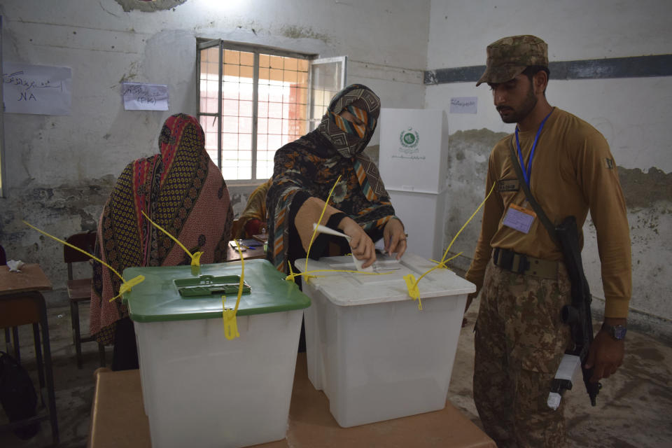 FILE - A woman casts her vote at a polling station for the parliamentary elections in Peshawar, Pakistan, July 25, 2018. Pakistan is holding elections for a new parliament on Thursday, Feb. 8, 2024. Forty-four political parties are vying for a share of the 266 seats that are up for grabs in the National Assembly, or the lower house of parliament. (AP Photo/Muhammad Sajjad, File)