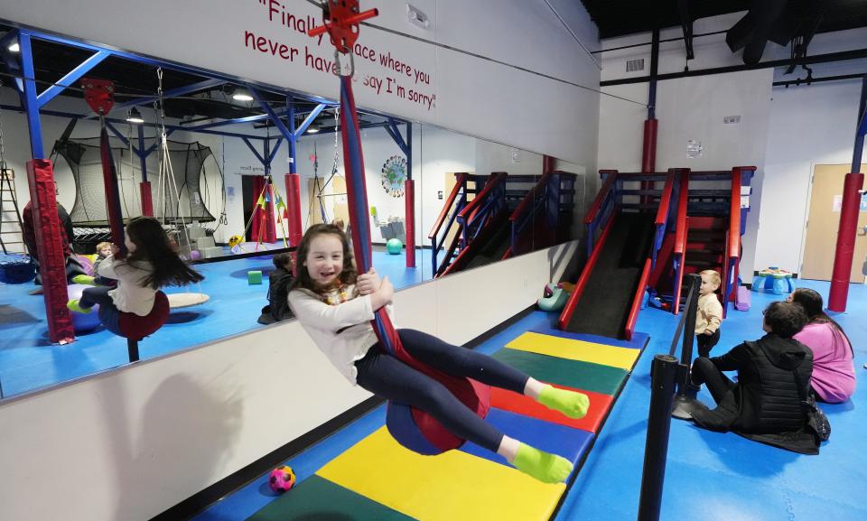 Avalie Dunn, 7, uses the gym's indoor zip line.