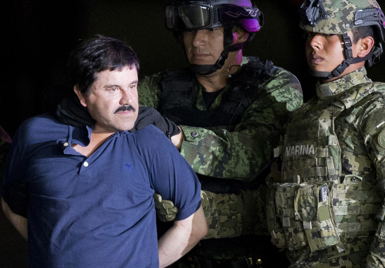 Handcuffed Joaquin “El Chapo” Guzman is made to face the press as he is escorted to a helicopter by Mexican soldiers and marines at a federal hangar in Mexico City. Mexico’s most notorious cartel kingpin who twice made brazen prison escapes and spent years on the run as the country’s most wanted man, was extradited to the United States on Thursday, Jan. 19, 2017, to face drug trafficking and other charges. (AP Photo/Eduardo Verdugo, File)