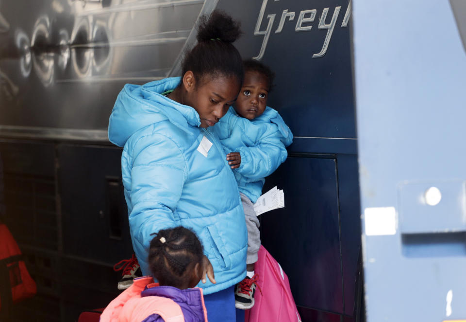 Immigrants from Central America seeking asylum board a bus, Tuesday, April 2, 2019, in downtown San Antonio. The surge of migrants arriving at the southern border has led the Trump administration to dramatically expand a practice it has long mocked as "catch and release." (AP Photo/Eric Gay)