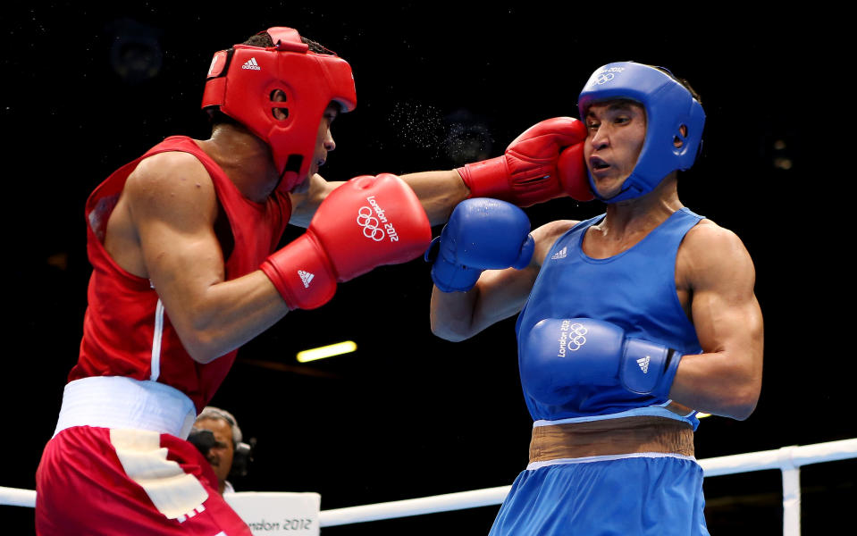 LONDON, ENGLAND - AUGUST 07: Serik Sapiyev of Kazakhstan (R) in action with Gabriel Maestre Prez of Venuzuela during the Men's Welter (69kg) Boxing on Day 11 of the London 2012 Olympic Games at ExCeL on August 7, 2012 in London, England. (Photo by Scott Heavey/Getty Images)