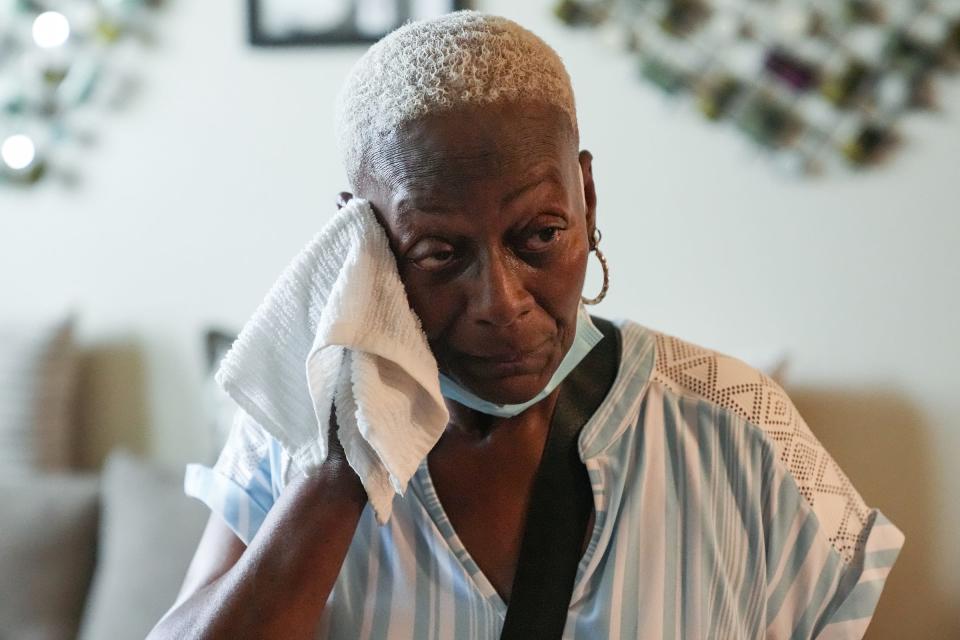 Regina Anderson, 63, a renter at Indianapolis Housing Agency's Millikan on Mass, wipes sweat from her face on June 14. The air conditioning had been out in her unit for a weekend despite a heat wave that week.
