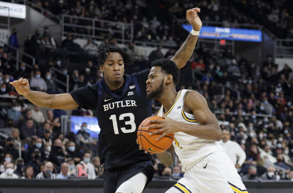 Providence guard Al Durham (1) drives against Butler guard Jayden Taylor (13) during the first half of an NCAA college basketball game, Sunday, Jan. 23, 2022, in Providence, R.I. (AP Photo/Mary Schwalm)