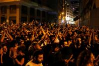 People gesture during a protest over deteriorating economic situation in Beirut