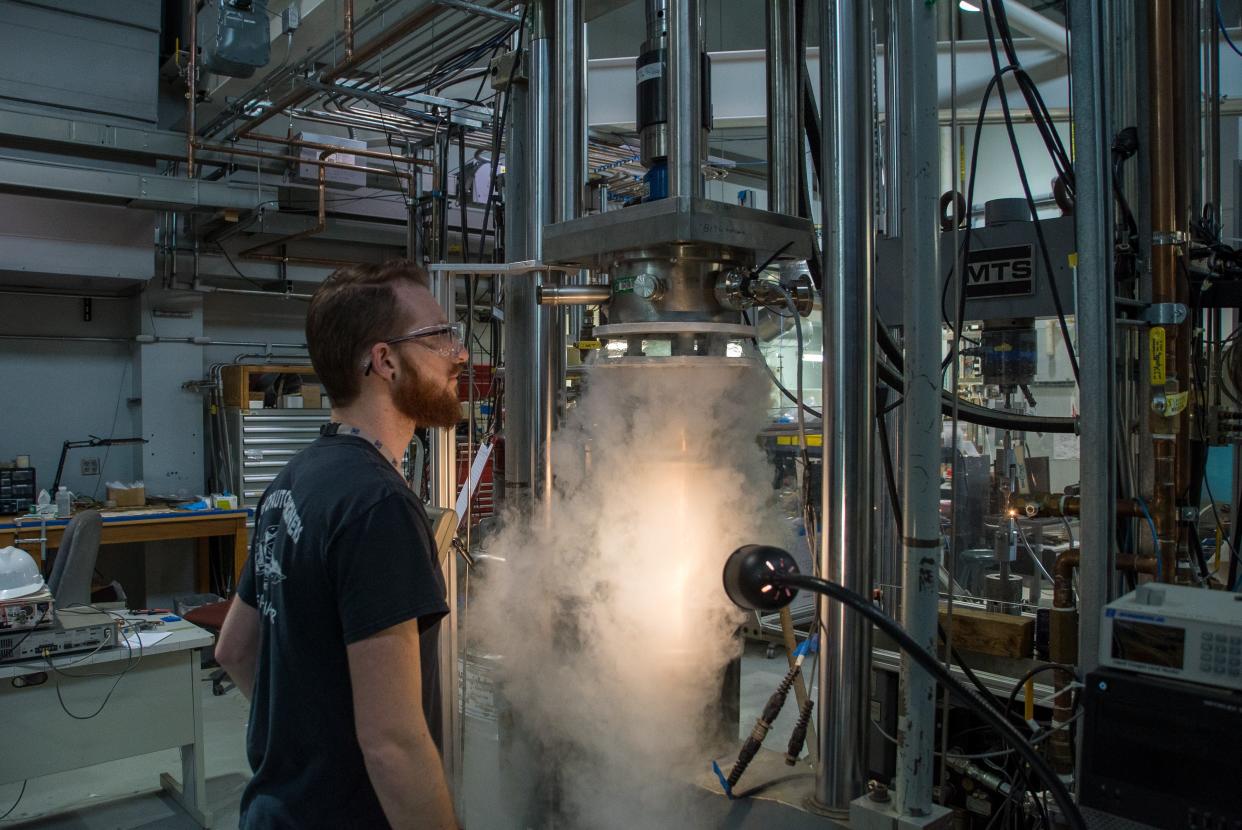 MagLab research assistant Kyle Radcliff tests the strength of aluminum samples in the lab's Mechanical and Physical Properties laboratory.