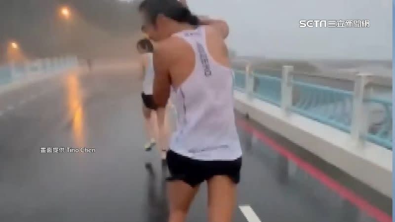 馬拉松活動遇上狂風暴雨，讓跑者邊跑邊用手遮擋大雨。（圖／Tino Chen提供）