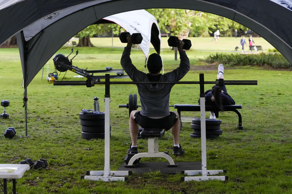 People workout in a park in the eastern suburbs of Sydney Tuesday, Sept. 14, 2021. Personal trainers have turned a waterfront park at Sydney’s Rushcutters Bay into an outdoor gym to get around pandemic lockdown restrictions. (AP Photo/Mark Baker)