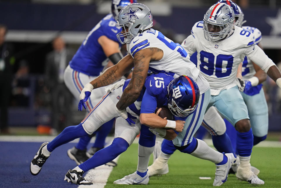New York Giants quarterback Tommy DeVito (15) is sacked by Dallas Cowboys defensive end Sam Williams, top, in the first half of an NFL football game, Sunday, Nov. 12, 2023, in Arlington, Texas. (AP Photo/Julio Cortez)