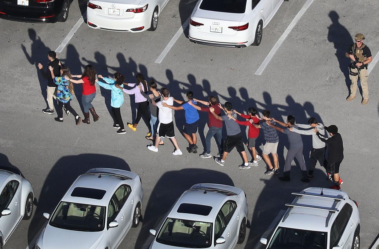 Children leave Marjory Stoneman Douglas High School in Parkland, Fla., following the Feb. 14, 2018, shooting.