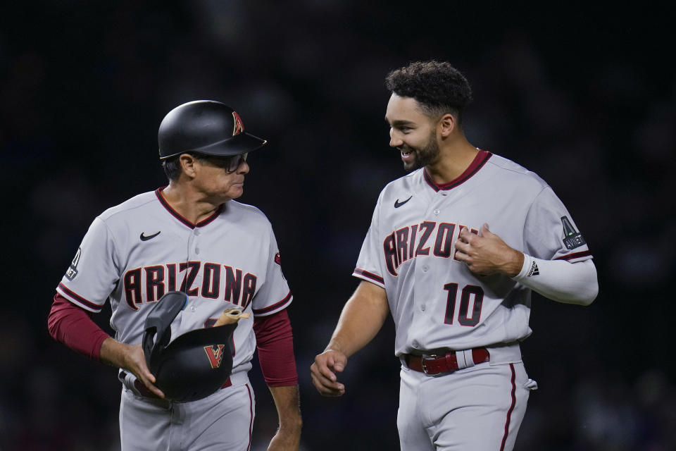 Arizona Diamondbacks' Jordan Lawlar, right, walks with third base coach Tony Perezchica during the fourth inning of the team's baseball game against the Chicago Cubs on Thursday, Sept. 7, 2023, in Chicago. (AP Photo/Erin Hooley)