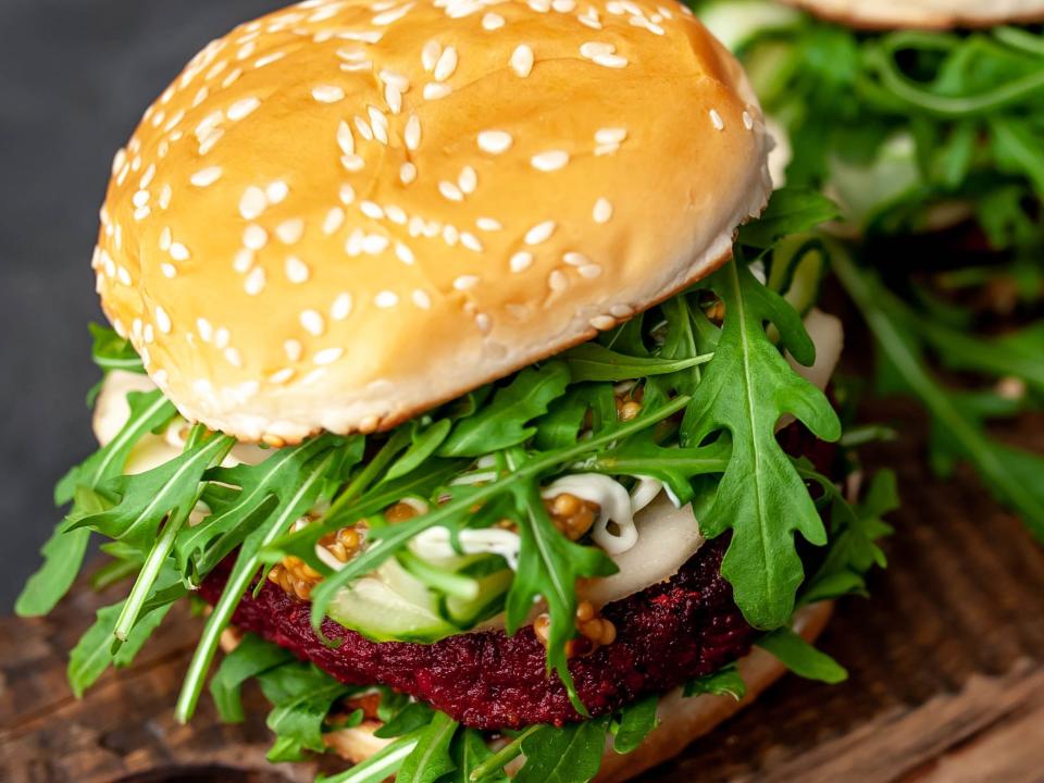 arugula on burger with sesame seed bun