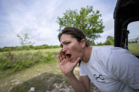 Meredith Ellis calls out to her cattle so they'll follow her to graze on a different pasture at her ranch in Rosston, Texas, Thursday, April 20, 2023. "We're looking for the sweet spot where the land and cattle help each other," Ellis says. "You want to find that balance." (AP Photo/David Goldman)