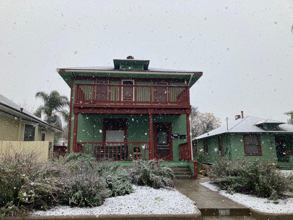 Snow falls in downtown Redlands on Saturday morning.