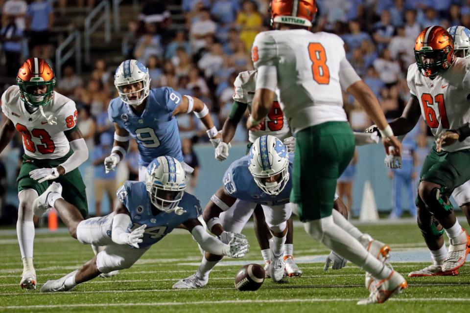 North Carolina's Cam'Ron Kelly (9), Dontae Balfour (14) and Cedric Gray (33) go for a fumble in front of Florida A&M's Darian Oxendine (83), Jeremy Moussa (8) and Jalen Goss (61) during the second half of an NCAA college football game in Chapel Hill, N.C., Saturday, Aug. 27, 2022. Balfour graduated from Bradford High School.
