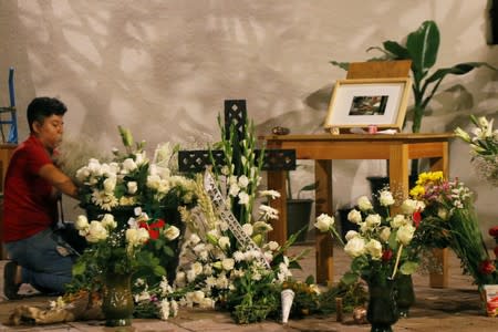 A man arranges flowers at a memorial for late Mexican graphic artist Francisco Toledo at the Graphic Arts Institute of Oaxaca (IAGO), in Oaxaca