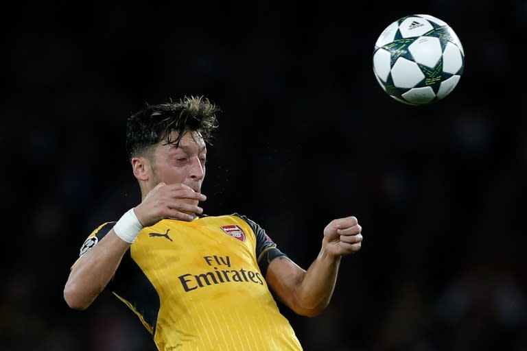 Arsenal's German midfielder Mesut Ozil heads the ball during the UEFA Champions League Group A football match between Arsenal and FC Basel