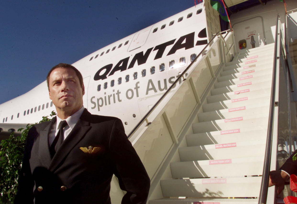 American actor John Travolta stands in front of the first production 747-400
Extended Range jetliner delivered to Australia's Qantas Airways in Everett,
Washington on October 30, 2002. Travolta, who is a commercial pilot
qualified to fly numerous aircraft including the 747 jetliner, is Qantas'
goodwill ambassador. He recently completed a 41,632-mile world tour flying
his personally owned 707 jetliner. REUTERS/Anthony P. Bolante

APB