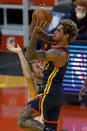 Golden State Warriors guard Kelly Oubre Jr., top, shoots over Minnesota Timberwolves forward Jake Layman during the first half of an NBA basketball game in San Francisco, Wednesday, Jan. 27, 2021. (AP Photo/Jeff Chiu)