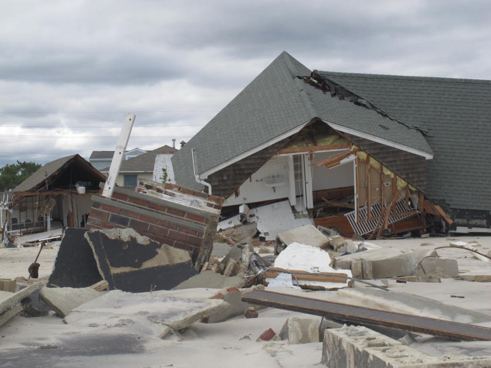 This Oct. 31, 2012 photo, taken two days after Superstorm Sandy, shows one of many homes destroyed by the storm in Mantoloking, N.J. On the 10th anniversary of the storm, government officials and residents say much has been done to protect against the next storm, but caution that much more still needs to be done to protect against future storms. (AP Photo/Wayne Parry)