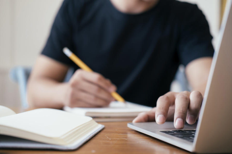 Someone studying on a laptop