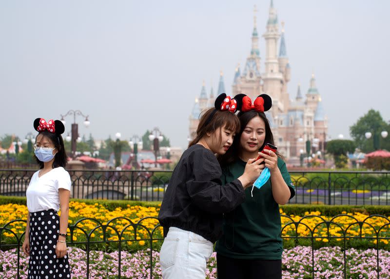 Visitors wears Minnie Mouse ears at Shanghai Disney Resort as the Shanghai Disneyland theme park reopens following a shutdown due to the coronavirus disease (COVID-19) outbreak, in Shanghai