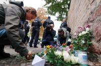 People lay flowers outside the synagogue in Halle