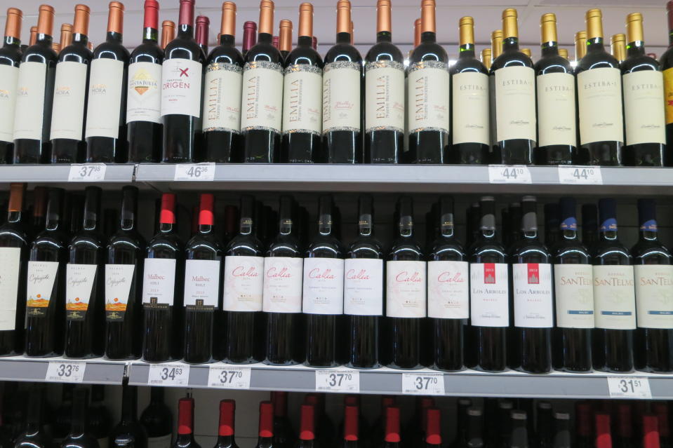 Rows of red wine in a supermarket in Argentina. Want to spend $5 on your next cup of Starbucks? Why not save it for a bottle of Argentinian Malbec at less than $5 when you’re there?