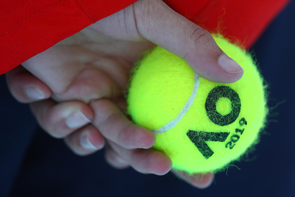 A ball held by a ball kid.