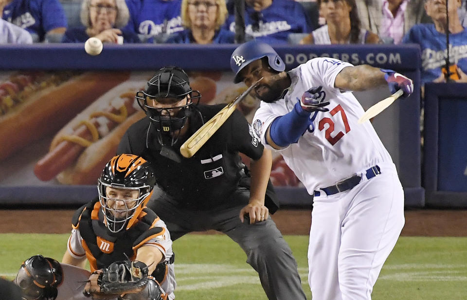 Los Angeles Dodgers' Matt Kemp, right, breaks his bat as he hits a single while San Francisco Giants catcher Buster Posey and home plate umpire Stu Scheurwater watch during the fifth inning of a baseball game Wednesday, Aug. 15, 2018, in Los Angeles. (AP Photo/Mark J. Terrill)