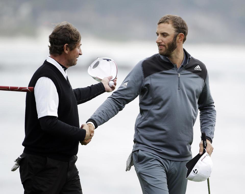 Dustin Johnson, right, is greeted by playing partner Wayne Gretzky, left, on the 18th green of the Pebble Beach Golf Links during the final round of the AT&T Pebble Beach Pro-Am golf tournament Sunday, Feb. 9, 2014, in Pebble Beach, Calif. Johnson finished tied for second place after shooting a 6-under-par 66 to finish at total 10-under-par. (AP Photo/Eric Risberg)