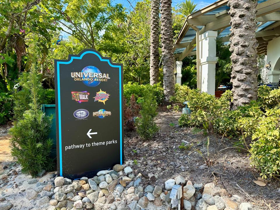 sign pointing to universal's theme parks and attractions at the hard rock hotel