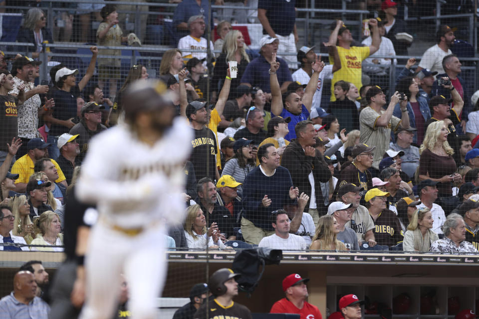 Fans stand up to cheer a home run by San Diego Padres' Fernando Tatis Jr. against the Cincinnati Reds during the sixth inning of a baseball game Thursday, June 17, 2021, in San Diego. (AP Photo/Derrick Tuskan)